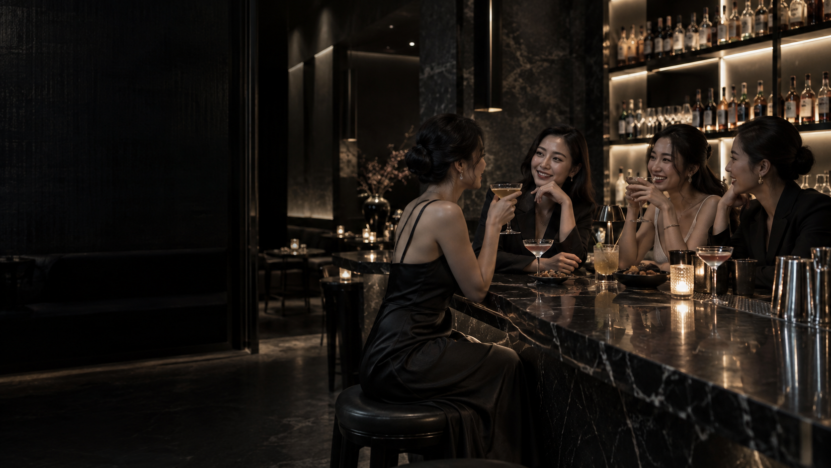 Elegant black-marble lounge with adult guests enjoying cocktails